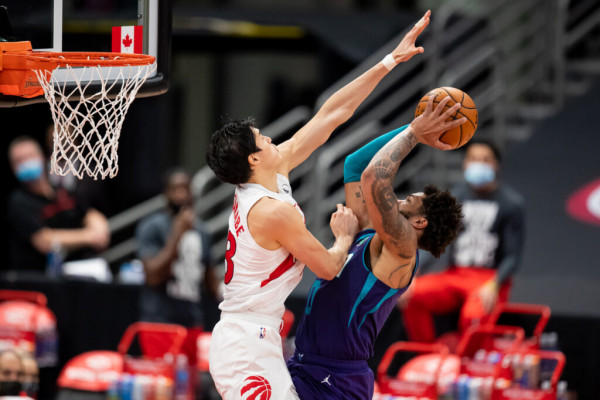 Jan 14, 2021; Tampa, Florida, USA; Toronto Raptors forward Yuta Watanabe (18) attempts to block a shot by Charlotte Hornets forward Miles Bridges (0) during the third quarter of a game at Amalie Arena. Mandatory Credit: Mary Holt-USA TODAY Sports