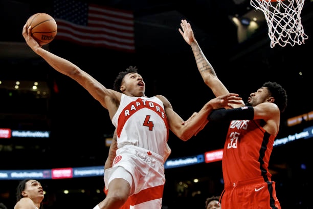 TORONTO, ON - OCTOBER 11: Scottie Barnes #4 of the Toronto Raptors puts up a shot over Christian Wood #35 of the Houston Rockets during preseason NBA game action at Scotiabank Arena on October 11, 2021 in Toronto, Canada. NOTE TO USER: User expressly acknowledges and agrees that,  by downloading and or using this photograph,  User is consenting to the terms and conditions of the Getty Images License Agreement. (Photo by Cole Burston/Getty Images)