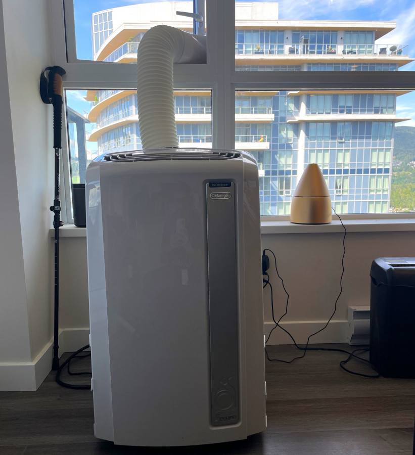 黃太將移動冷氣從雜物室搬至單文中。受訪者提供