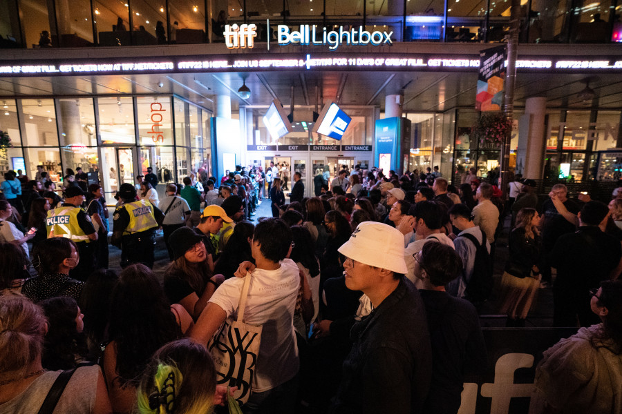 Fans of Taylor Swift wait outside of the TIFF Bell Lightbox in hopes of catching a glimpse of the musician during the Toronto International Film Festival in Toronto on Friday, September 9, 2022. THE CANADIAN PRESS/Alex Lupul