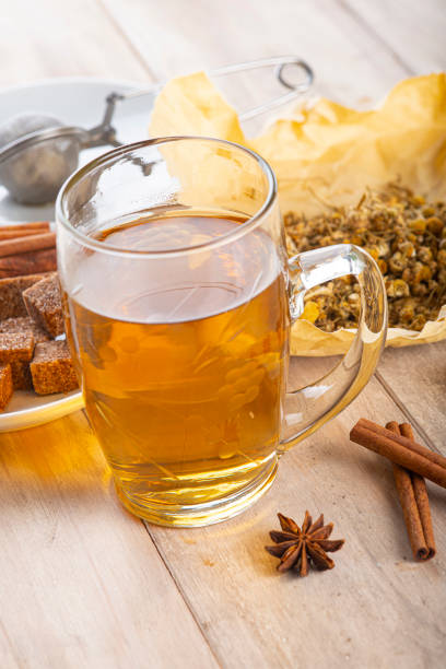 Hot chamomile tea made of wild flowers with a mesh ball tea infuser