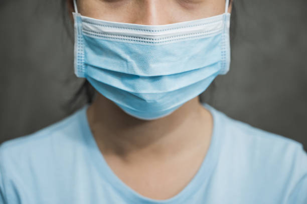 Close up young asian woman wearing protection face mask against coronavirus.