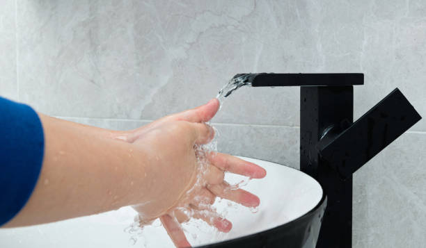 Boy washing hands in the bathroom.